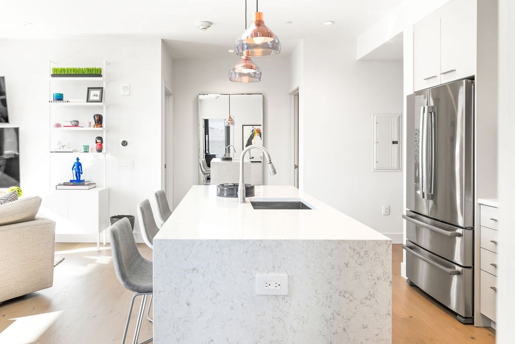 40 Traveler Street, Unit 303 Boston, MA 02118 - Photo 13 of 42 a kitchen with stainless steel appliances granite countertop a refrigerator and a sink