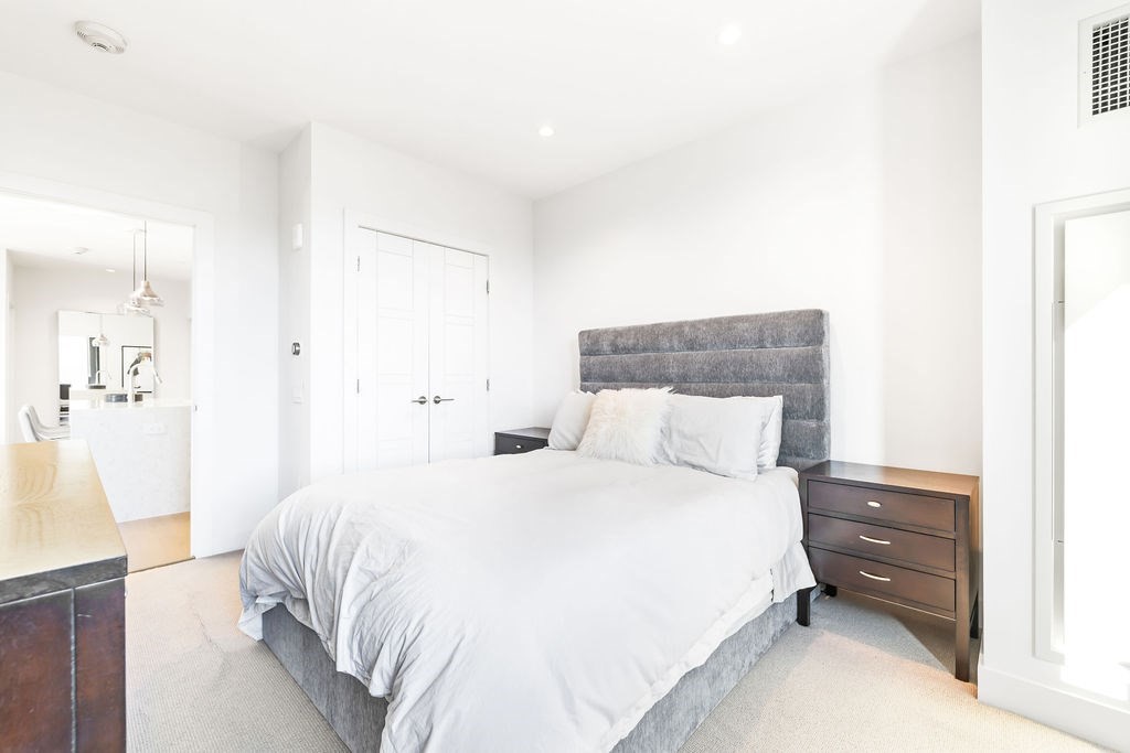 40 Traveler Street, Unit 303 Boston, MA 02118 - Photo 15 of 42 a bedroom with a bed and a painting