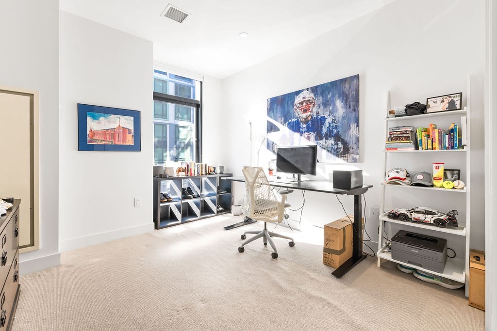 40 Traveler Street, Unit 303 Boston, MA 02118 - Photo 19 of 42 a view of a livingroom with furniture and a workspace