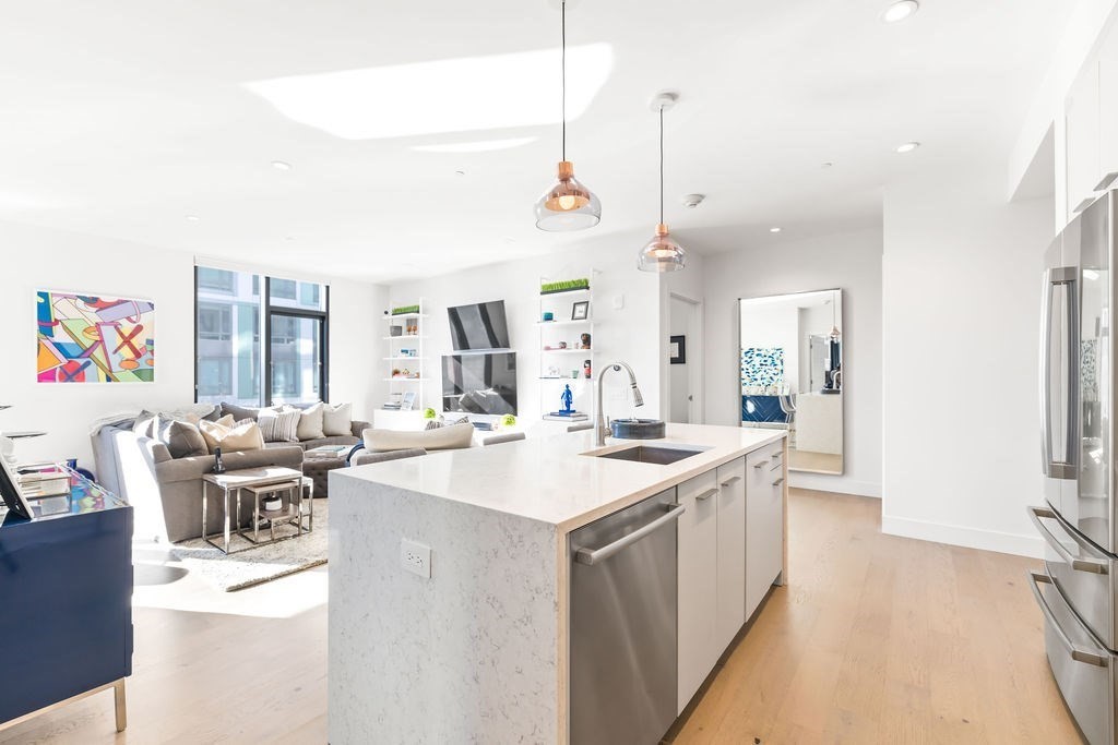 40 Traveler Street, Unit 303 Boston, MA 02118 - Photo 2 of 42 a kitchen with a sink stove and wooden floor