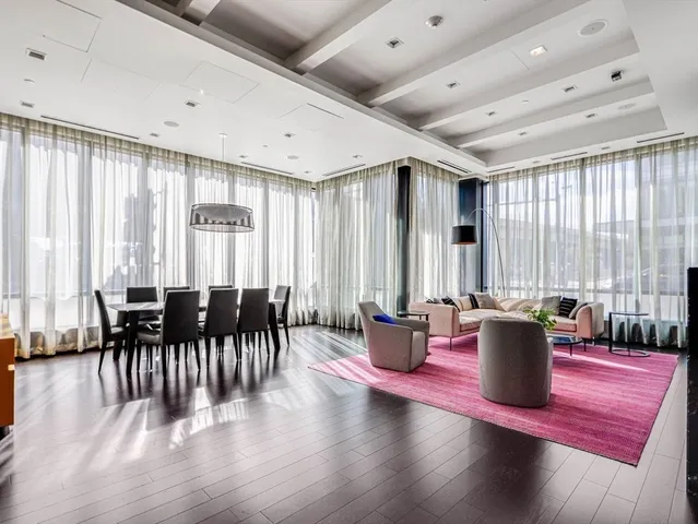 a dining room with wooden floor and furniture