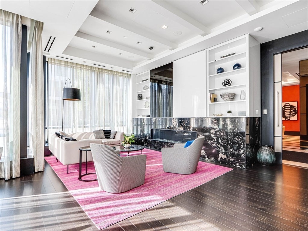 40 Traveler Street, Unit 303 Boston, MA 02118 - Photo 30 of 42 a living room with furniture and a wooden floor