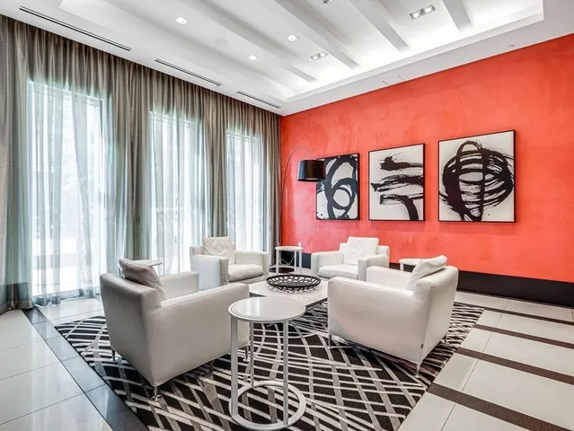 a living room with furniture and large window