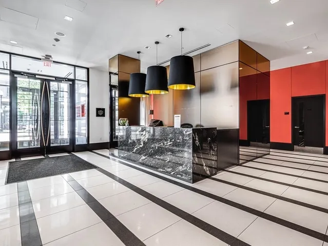 a kitchen with stainless steel appliances kitchen island granite countertop a refrigerator and a stove