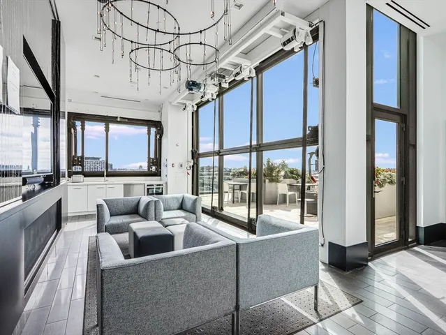a living room with furniture and a floor to ceiling window