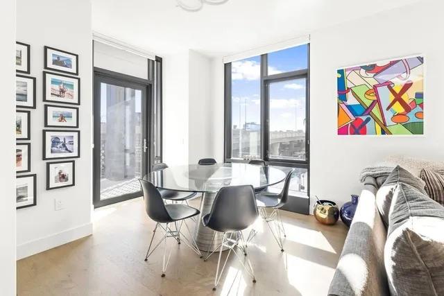a living room with furniture and floor to ceiling windows