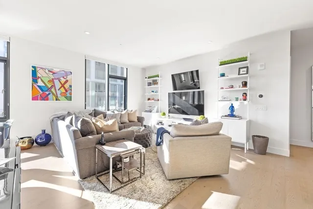 a living room with fireplace furniture and a window