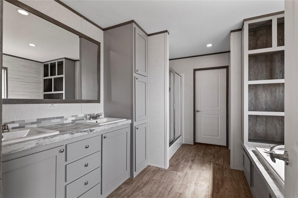 3888 Sandusky Road Whitesboro, TX 76273 - Photo 14 of 24 Bathroom featuring double vanity, a shower stall, light wood-style flooring, recessed lighting, and a garden tub