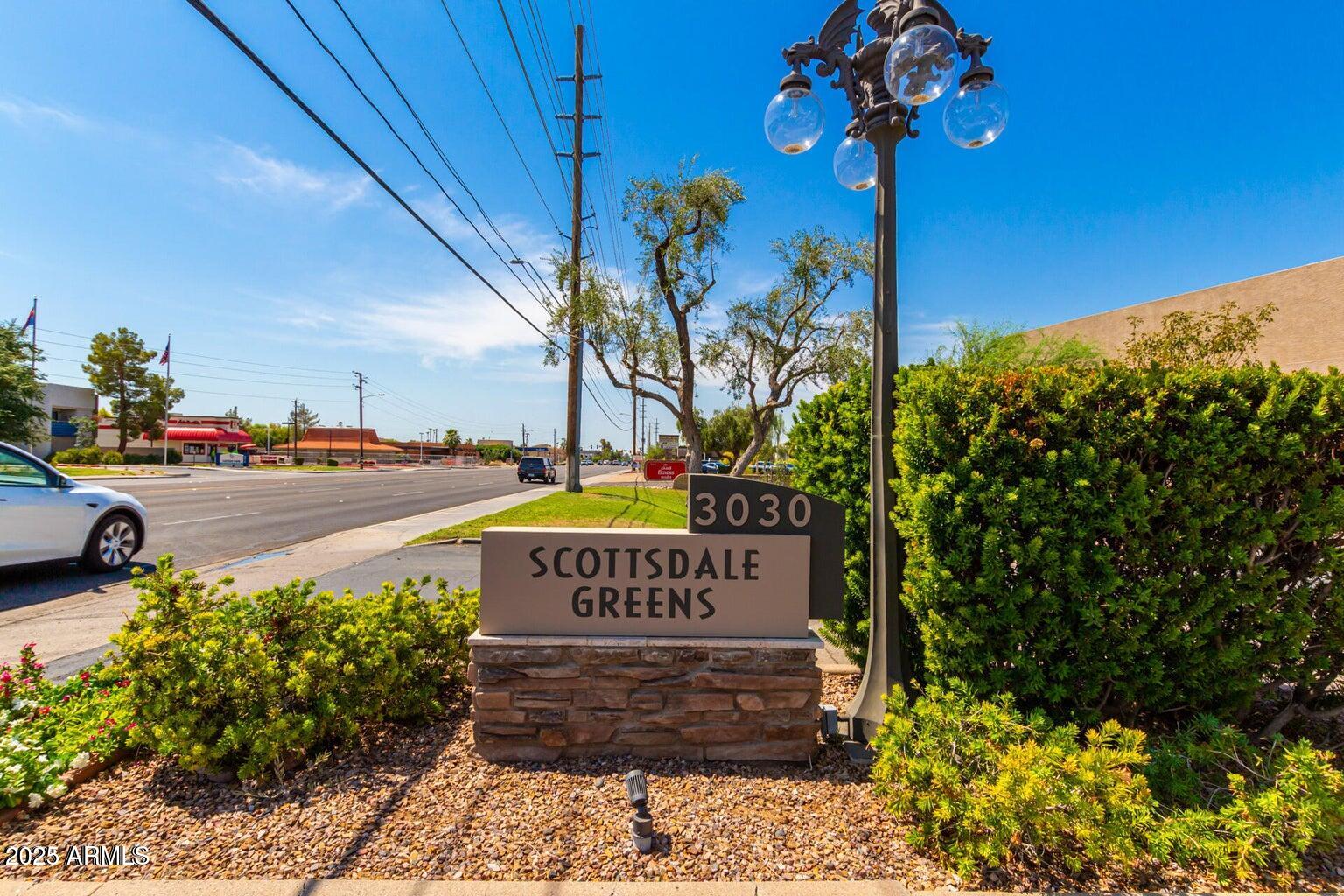 a view of a street with potted plants