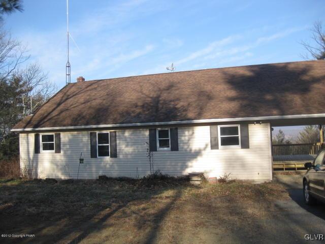 a view of house with backyard