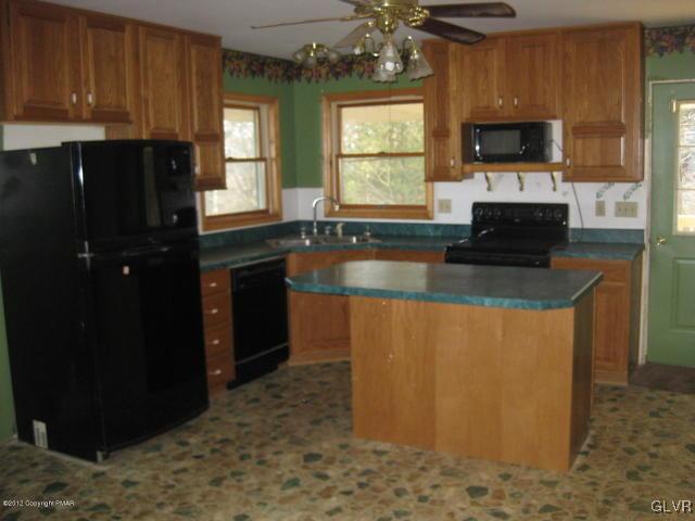 24 Turkey Ridge Kunkletown, PA 18058 - Photo 6 of 9 a kitchen with granite countertop a refrigerator and a stove top oven