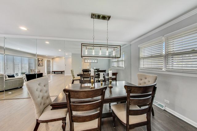 a view of a dining room with furniture and window
