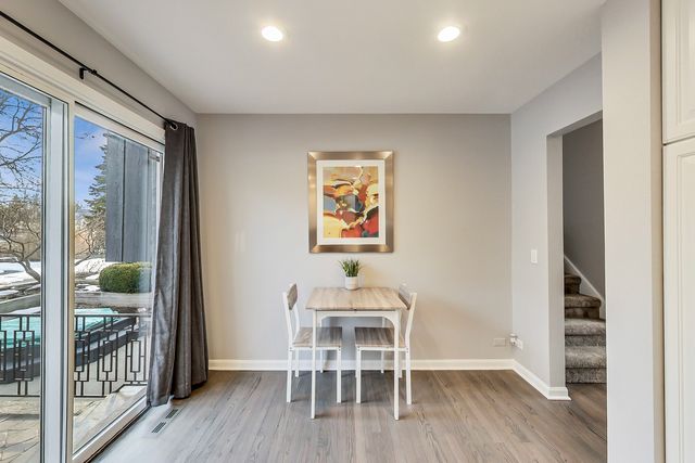 a dining room with furniture and wooden floor