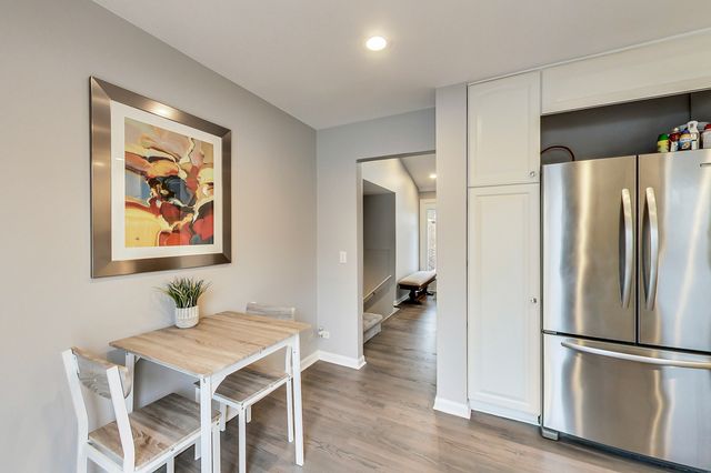 a kitchen with stainless steel appliances a refrigerator and a stove top oven