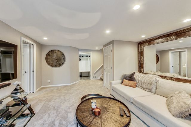 a living room with furniture and a large mirror