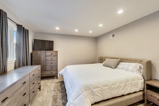 a bathroom with a granite countertop sink toilet a mirror a vanity and shower