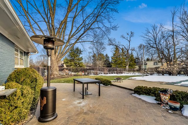 a view of a house with swimming pool and sitting area