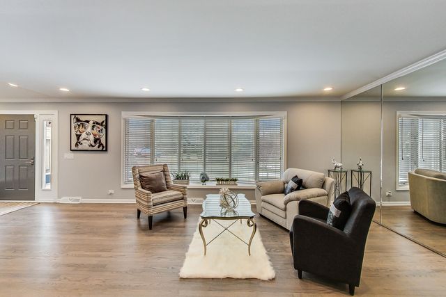 a living room with furniture and large windows
