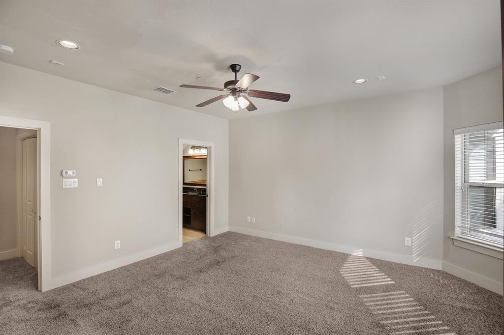 4111 Rawlins Street, Unit 403 Dallas, TX 75219 - Photo 16 of 23 Spacious room featuring neutral carpeting, a ceiling fan with integrated lighting, and recessed ceiling lights