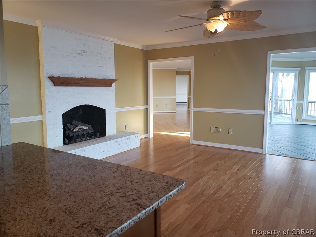 589 Brandon Point Road Locust Hill, VA 23092 - Photo 14 of 39 Kitchen bar overlooks dining area/great room with fireplace. Looking toward Living room and Florida Room.