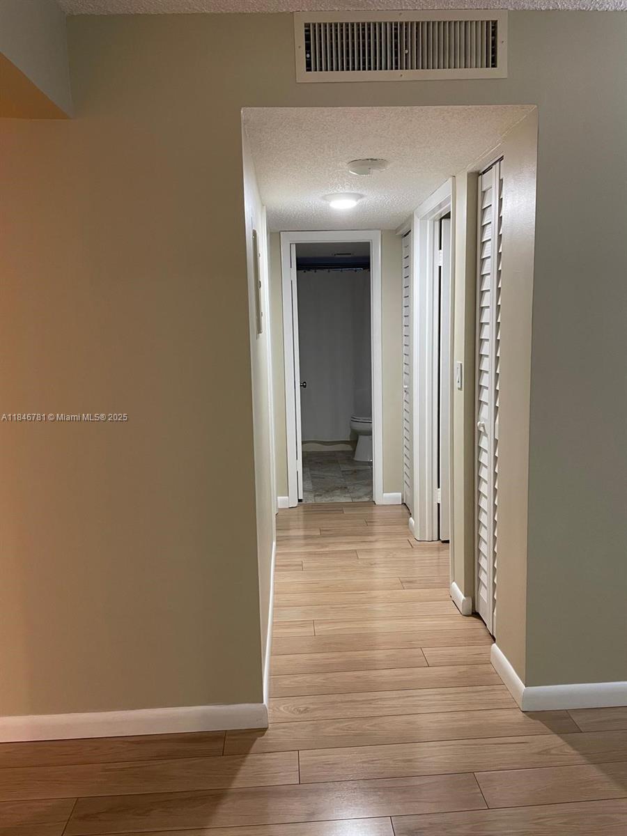121 Southeast 3rd Avenue, Unit 201 Dania Beach, FL 33004 - Photo 13 of 49 a view of a hallway with wooden floor