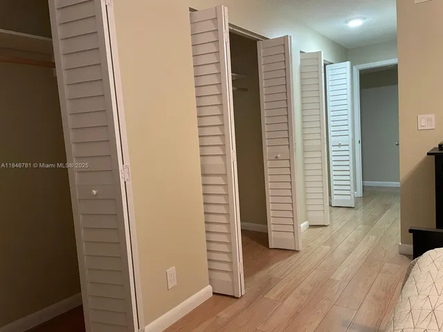 a view of hallway with wooden floor