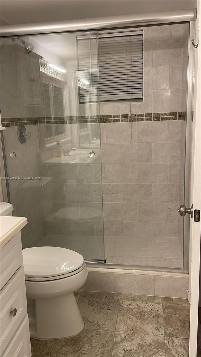 121 Southeast 3rd Avenue, Unit 201 Dania Beach, FL 33004 - Photo 20 of 49 a bathroom with a toilet and a shower