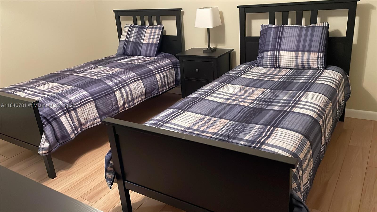 121 Southeast 3rd Avenue, Unit 201 Dania Beach, FL 33004 - Photo 23 of 49 a bedroom with a bed and dresser