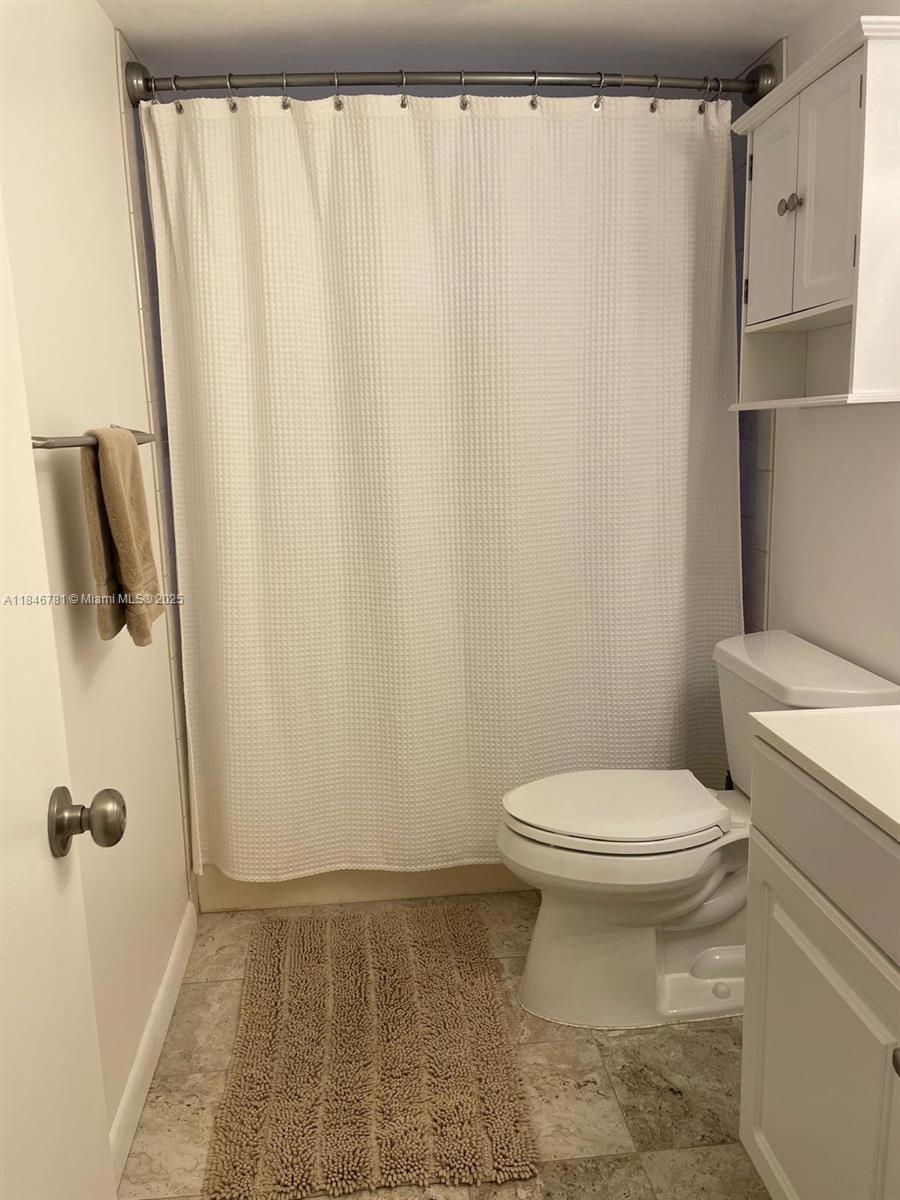 121 Southeast 3rd Avenue, Unit 201 Dania Beach, FL 33004 - Photo 25 of 49 a bathroom with a sink and a toilet