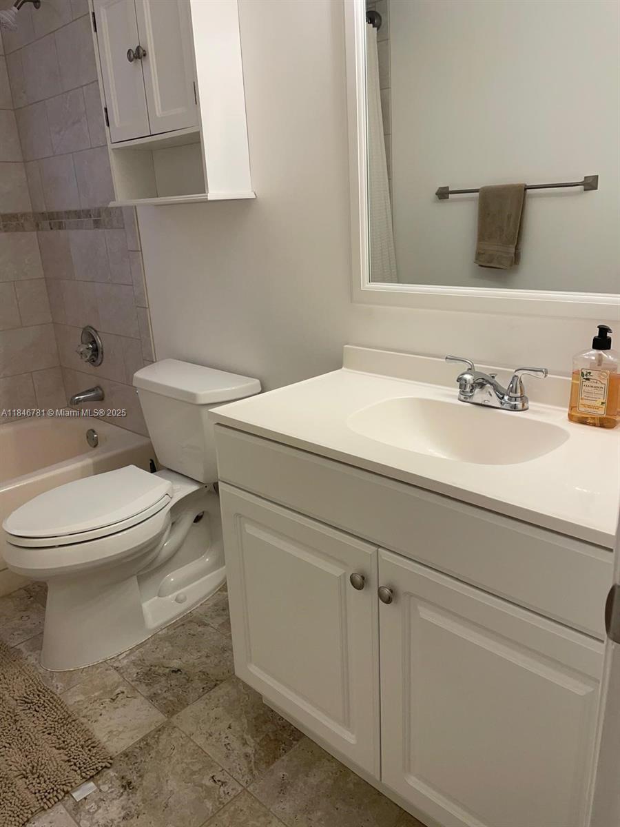121 Southeast 3rd Avenue, Unit 201 Dania Beach, FL 33004 - Photo 28 of 49 a bathroom with a sink a toilet and mirror