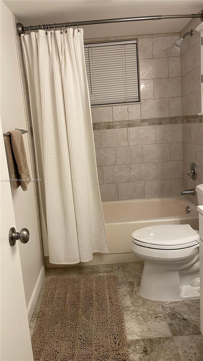 121 Southeast 3rd Avenue, Unit 201 Dania Beach, FL 33004 - Photo 29 of 49 a bathroom with a toilet and a shower