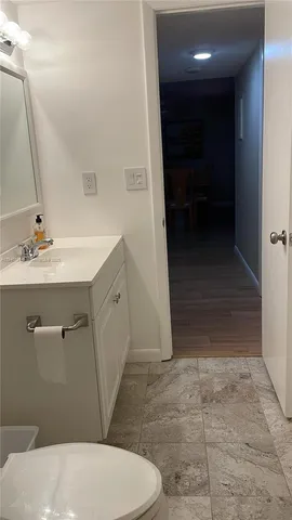 a bathroom with a sink a toilet and a mirror