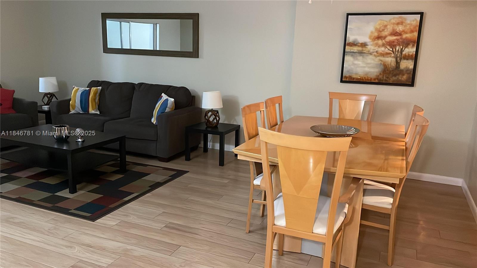 121 Southeast 3rd Avenue, Unit 201 Dania Beach, FL 33004 - Photo 3 of 49 a living room with furniture and a wooden floor