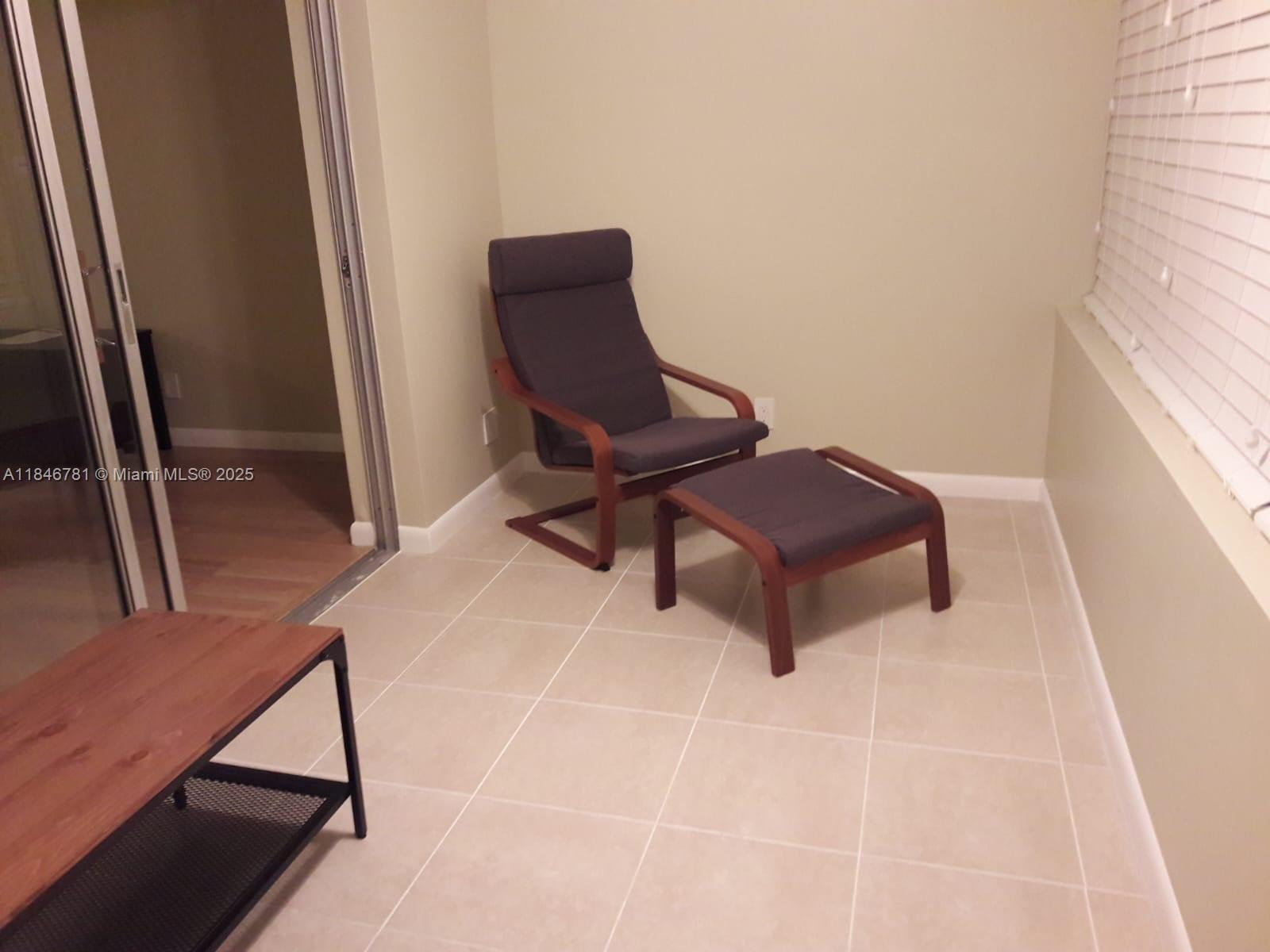 121 Southeast 3rd Avenue, Unit 201 Dania Beach, FL 33004 - Photo 32 of 49 a living room with a chair