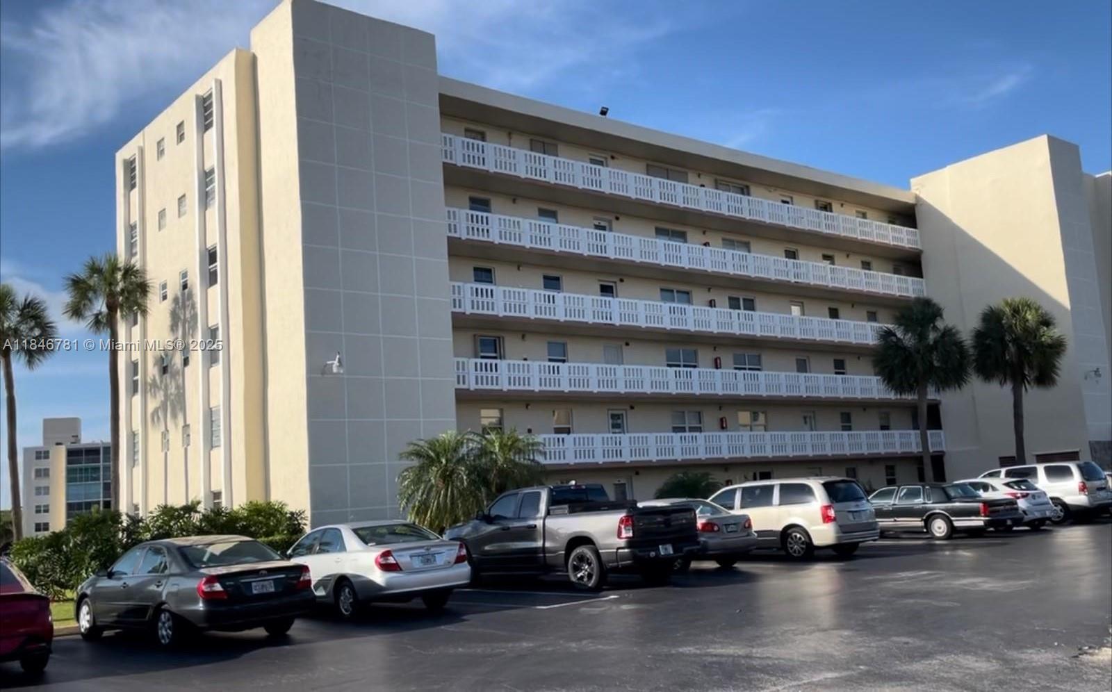 121 Southeast 3rd Avenue, Unit 201 Dania Beach, FL 33004 - Photo 39 of 49 a view of cars parked in front of a building