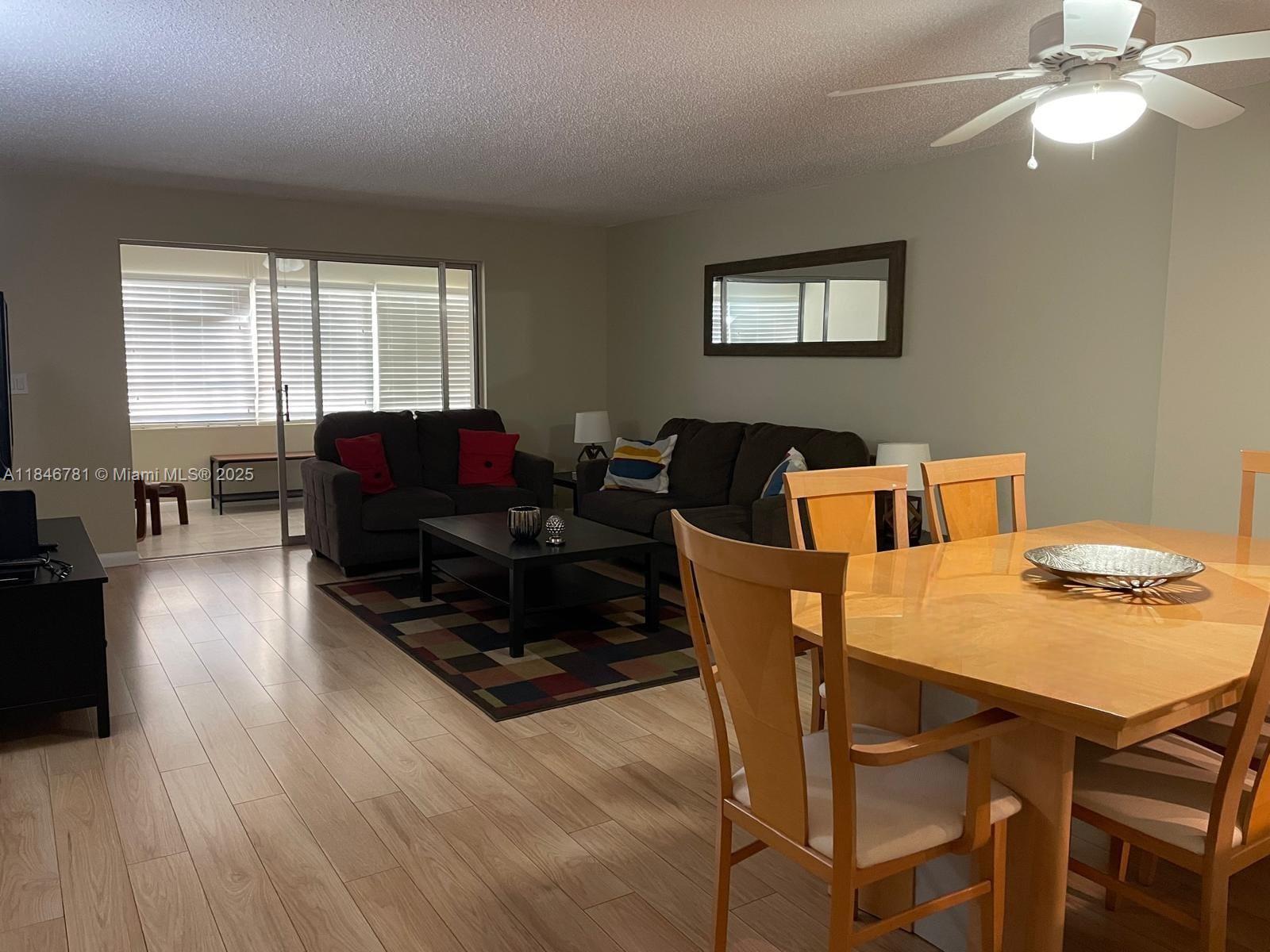 121 Southeast 3rd Avenue, Unit 201 Dania Beach, FL 33004 - Photo 4 of 49 a living room with furniture and wooden floor