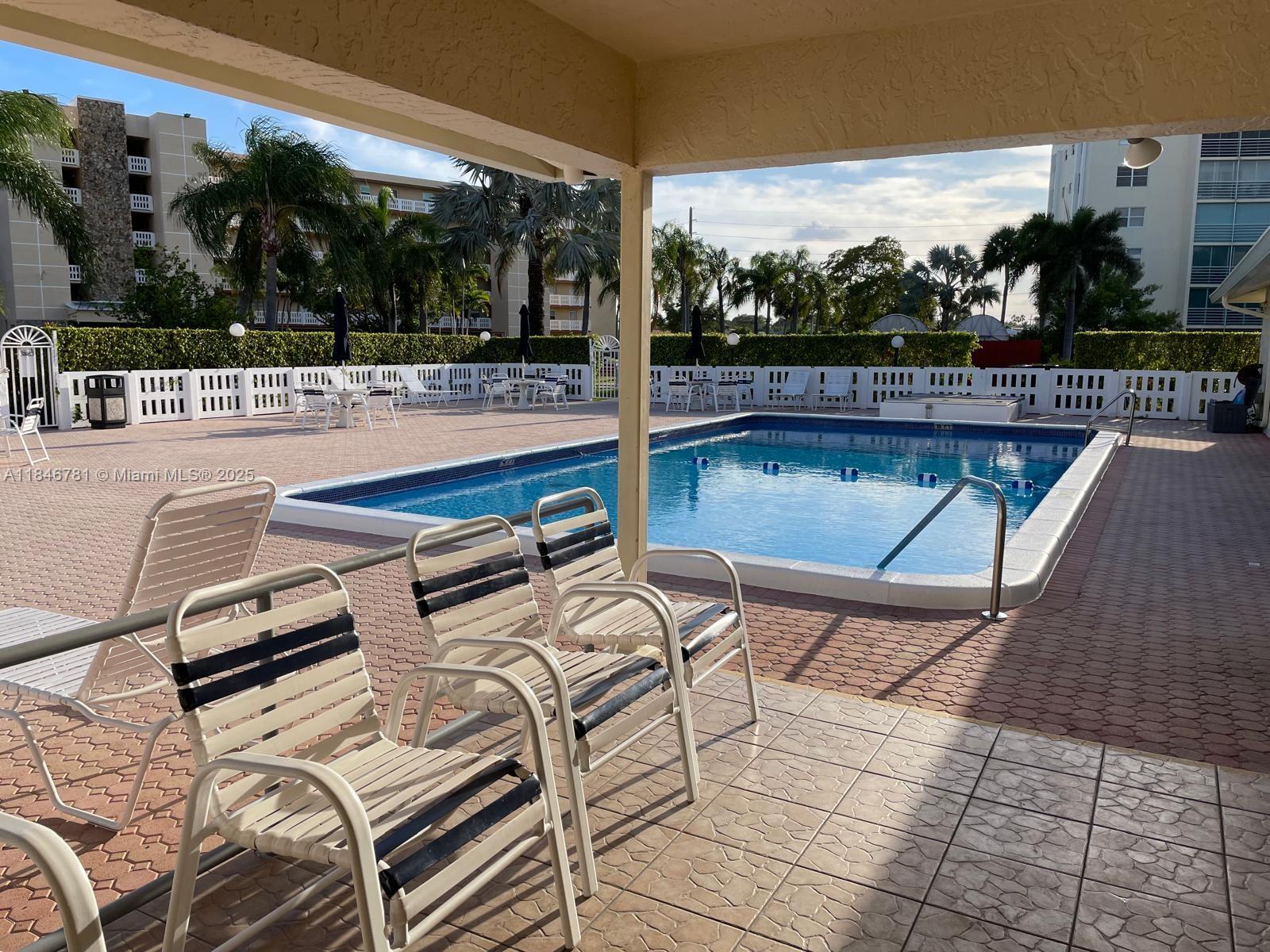 121 Southeast 3rd Avenue, Unit 201 Dania Beach, FL 33004 - Photo 42 of 49 a view of a patio with couches chairs and a table