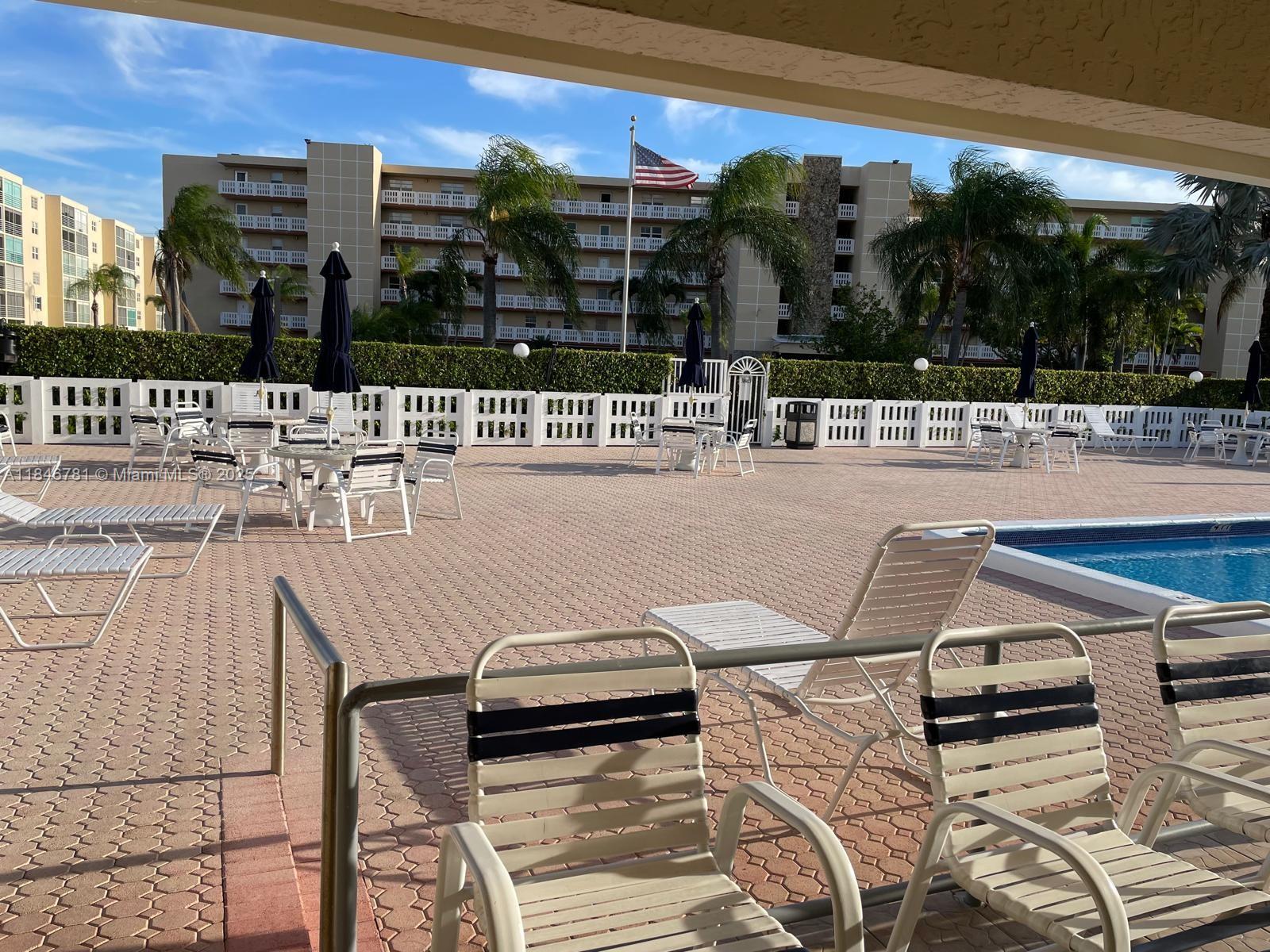 121 Southeast 3rd Avenue, Unit 201 Dania Beach, FL 33004 - Photo 45 of 49 a view of a patio with chairs and potted plants