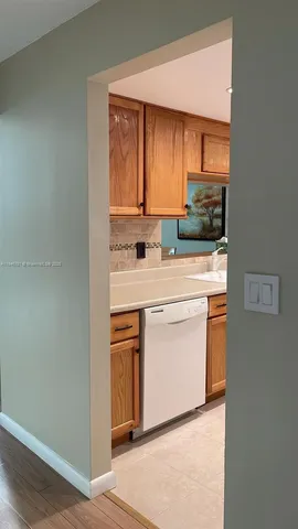 a kitchen with stainless steel appliances a sink stove and cabinets