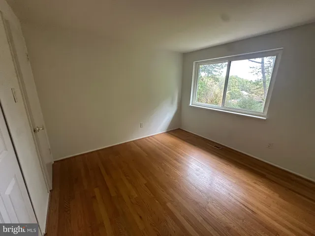 a view of an empty room and wooden floor