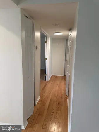a view of hallway with wooden floor