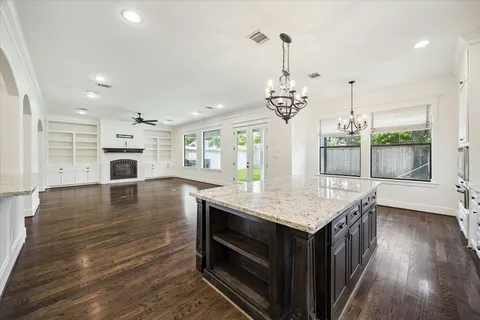 a kitchen with a stove and a wooden floors