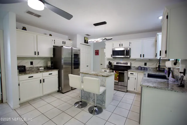 a kitchen with a sink cabinets and stainless steel appliances