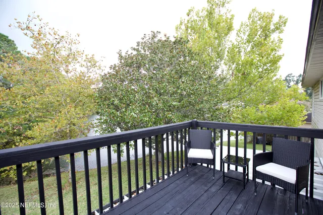 a view of a balcony with wooden floor