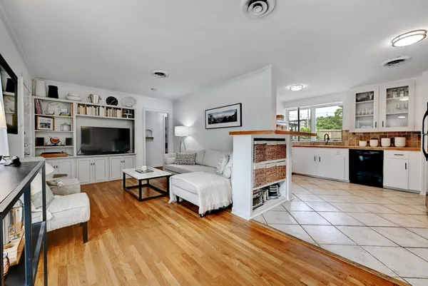 a living room with furniture and wooden floor