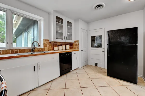 a kitchen with granite countertop a refrigerator and a stove