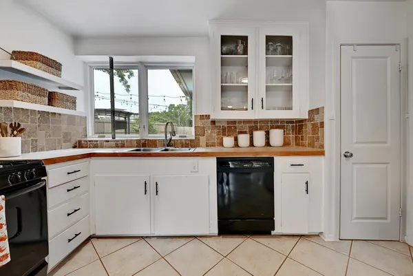 a kitchen with stainless steel appliances kitchen island granite countertop a refrigerator and a stove top oven