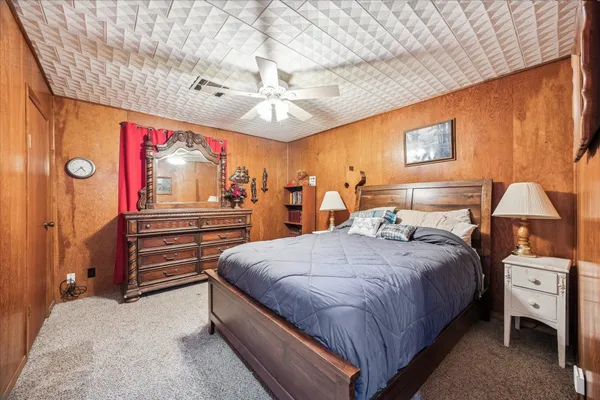 a bedroom with bed and wooden floor