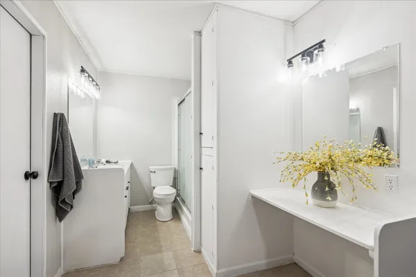 a bathroom with a sink a toilet and a shower