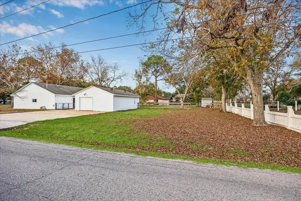 a view of a house with garage and yard